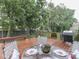 Well staged backyard wood deck with outdoor grill and table and chairs with backyard views at 8415 Alcona Dr, Indianapolis, IN 46237