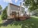 Spacious backyard with a two-level wooden deck and a chimney at 8415 Alcona Dr, Indianapolis, IN 46237
