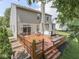 Spacious backyard with a two-level wooden deck, hot tub, and grill at 8415 Alcona Dr, Indianapolis, IN 46237