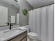 This bathroom has granite counters, a walk in shower and a modern sink at 8415 Alcona Dr, Indianapolis, IN 46237