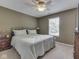 Cozy bedroom with warm colors, carpet, and a ceiling fan at 8415 Alcona Dr, Indianapolis, IN 46237