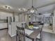 Open concept dining area with wood floors adjoining the kitchen and living spaces at 8415 Alcona Dr, Indianapolis, IN 46237