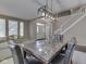 Bright dining room featuring a marble table, modern chandelier, and staircase access at 8415 Alcona Dr, Indianapolis, IN 46237