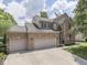 Charming two-story brick home featuring an attached two-car garage and well-maintained landscaping at 8415 Alcona Dr, Indianapolis, IN 46237