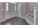 Bright foyer with hardwood floors, staircase, and a welcoming entrance, offering a warm invitation at 8415 Alcona Dr, Indianapolis, IN 46237