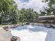A close-up view of the hot tub filled with bubbling water, surrounded by lush greenery at 8415 Alcona Dr, Indianapolis, IN 46237