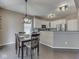 Eat-in kitchen with white cabinetry, stainless steel appliances, and wood floors at 8415 Alcona Dr, Indianapolis, IN 46237