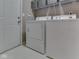 Laundry room features side by side washer and dryer with wire shelf at 8415 Alcona Dr, Indianapolis, IN 46237