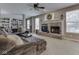 Cozy living room showcasing a brick fireplace, built-in shelves, and comfortable seating at 8415 Alcona Dr, Indianapolis, IN 46237