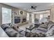 Inviting living room with brick fireplace, plush seating, and an open view to the dining area at 8415 Alcona Dr, Indianapolis, IN 46237
