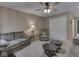 Living room features neutral walls, ceiling fan, carpeted floors, and cozy furniture at 8415 Alcona Dr, Indianapolis, IN 46237