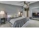 Spacious main bedroom features soft carpet, a ceiling fan, and neutral colors at 8415 Alcona Dr, Indianapolis, IN 46237