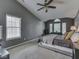 This is a spacious bedroom with gray walls, carpet, and a ceiling fan at 8415 Alcona Dr, Indianapolis, IN 46237