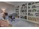 Well-lit office with built-in shelving, desk space, and comfortable seating at 8415 Alcona Dr, Indianapolis, IN 46237