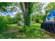 Backyard features lush greenery, play set and lots of space to enjoy at 8540 E 37Th Pl, Indianapolis, IN 46226