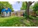 Brick house with deck and large backyard with mature trees and foliage at 8540 E 37Th Pl, Indianapolis, IN 46226