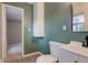 Green bathroom featuring modern vanity, sink and mirror at 8540 E 37Th Pl, Indianapolis, IN 46226