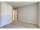 This bedroom features neutral carpeting, a large closet and access to other rooms at 8540 E 37Th Pl, Indianapolis, IN 46226