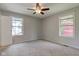 Spacious bedroom features a ceiling fan, carpeted floors and large windows at 8540 E 37Th Pl, Indianapolis, IN 46226