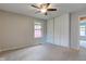 The bedroom has carpeted floors, a ceiling fan, and a view of the backyard at 8540 E 37Th Pl, Indianapolis, IN 46226