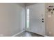 Clean, bright entryway with white front door, side window, and key rack on the wall at 8540 E 37Th Pl, Indianapolis, IN 46226