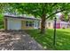 Single story brick home featuring a well-manicured lawn and paved driveway at 8540 E 37Th Pl, Indianapolis, IN 46226