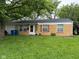 Charming brick ranch-style home with a well-maintained lawn, quaint shutters, and attached garage at 8540 E 37Th Pl, Indianapolis, IN 46226
