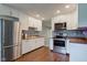 Bright kitchen featuring white cabinets, stainless steel appliances, and hardwood floors at 8540 E 37Th Pl, Indianapolis, IN 46226