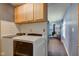 Laundry room featuring a white washer and dryer leading to living room at 8540 E 37Th Pl, Indianapolis, IN 46226