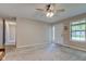 Inviting living room with plush carpeting, ceiling fan, and ample natural light at 8540 E 37Th Pl, Indianapolis, IN 46226