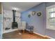 Inviting living room featuring a white stone fireplace, hardwood floors, and blue walls at 8540 E 37Th Pl, Indianapolis, IN 46226