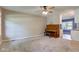 Spacious living room with plush carpeting, ceiling fan, and grand piano at 8540 E 37Th Pl, Indianapolis, IN 46226