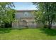 Spacious backyard features a wooden deck, green lawn, mature trees, and a fenced perimeter offering privacy at 8578 Nolan Dr, Fishers, IN 46038