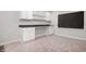 Basement office area with a built-in desk and cabinets, carpet, and a chalkboard at 8578 Nolan Dr, Fishers, IN 46038