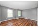 This bedroom has laminate flooring, gray walls, two windows that let in natural light, and white trim at 8578 Nolan Dr, Fishers, IN 46038