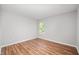 Bright bedroom features modern laminate flooring, neutral walls, and ample natural light through a single window at 8578 Nolan Dr, Fishers, IN 46038