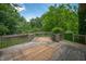 Wooden deck overlooking a lush, green backyard with mature trees at 8578 Nolan Dr, Fishers, IN 46038