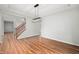 An empty dining room area with laminate wood floors, a modern light fixture, and stairs at 8578 Nolan Dr, Fishers, IN 46038