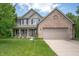 Charming two-story home featuring a brick facade, vinyl siding, and a well-manicured front lawn at 8578 Nolan Dr, Fishers, IN 46038