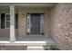 Close-up of the front door, framed by brick and sidelights, providing a grand entrance to the home at 8578 Nolan Dr, Fishers, IN 46038
