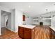 Open kitchen featuring an island, modern lighting, and views into the living room with a fireplace at 8578 Nolan Dr, Fishers, IN 46038