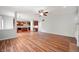 Open-concept living area with hardwood floors, seamlessly connecting to the kitchen with abundant natural light at 8578 Nolan Dr, Fishers, IN 46038