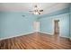 Main bedroom with blue walls, ceiling fan, laminate floors, a bathroom, and a walk-in closet at 8578 Nolan Dr, Fishers, IN 46038