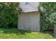 Backyard shows a painted wooden storage shed surrounded by leafy green trees and lawn at 8578 Nolan Dr, Fishers, IN 46038