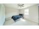 Cozy bedroom features a ceiling fan, neutral walls, plush carpet, and a comfortable bed at 901 N Greenbriar Rd, Muncie, IN 47304