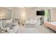 Spacious bedroom designed as Bedroom with crib, seating, and mounted television at 901 N Greenbriar Rd, Muncie, IN 47304
