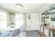 Bright dining area with modern decor, natural light, and sleek gray flooring at 901 N Greenbriar Rd, Muncie, IN 47304