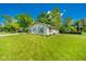 Expansive lawn and charming home featuring mature shade trees and a well manicured yard at 901 N Greenbriar Rd, Muncie, IN 47304