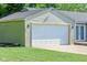 A large detached two car garage stands separate from the house with nice curb appeal at 901 N Greenbriar Rd, Muncie, IN 47304
