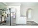 Bright kitchen featuring stainless steel refrigerator, ample storage, and modern gray flooring at 901 N Greenbriar Rd, Muncie, IN 47304